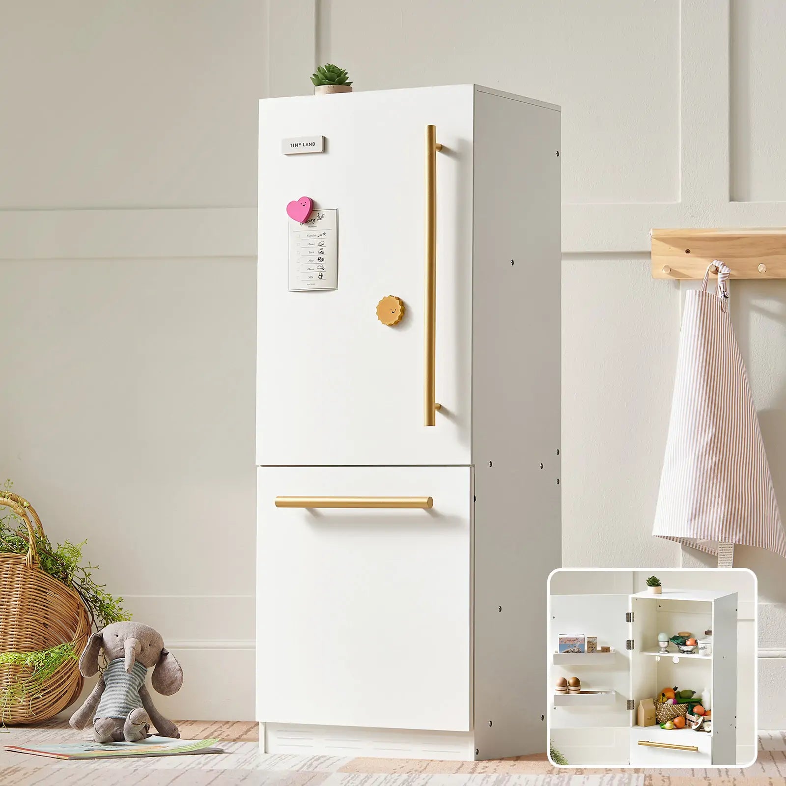 White refrigerator with gold handles in a room setting with a basket, teddy bear, and small shelf.
